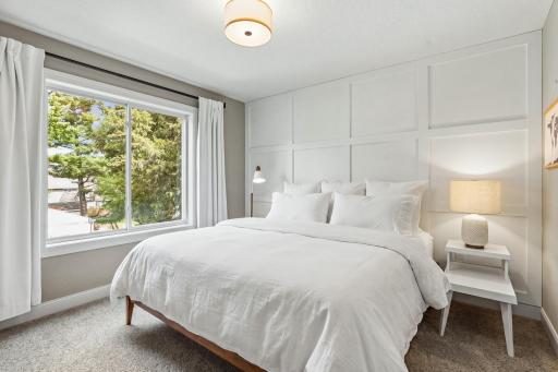 Bright bedroom with board-and-batten accent wall and versatile layout.