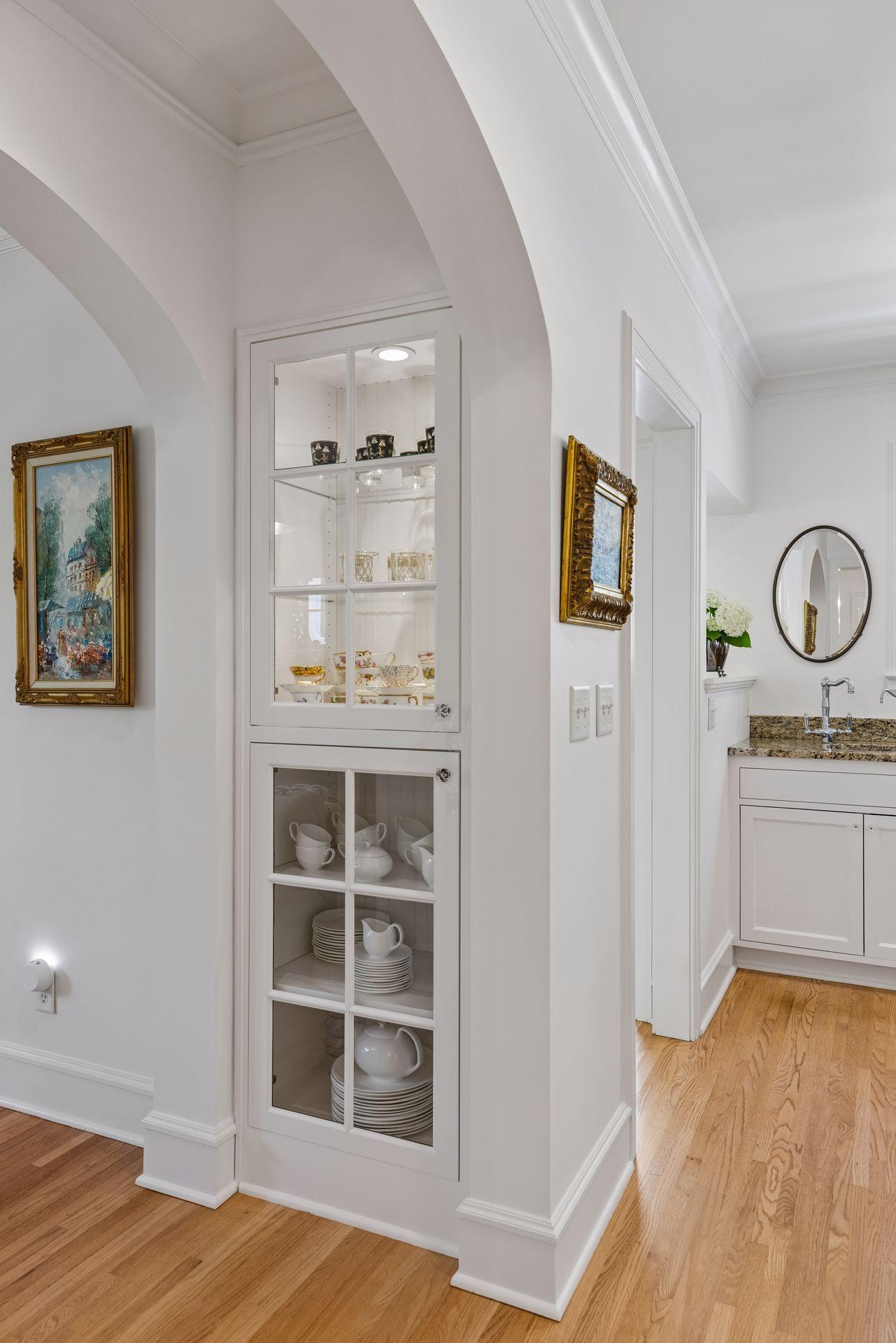 Custom cabinets in archway from living leading into kitchen.