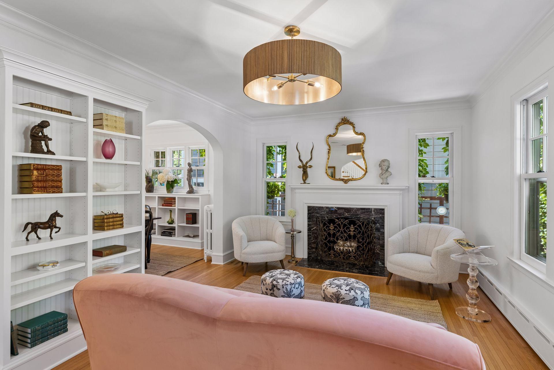 Living room leads through archway into formal dining room space.