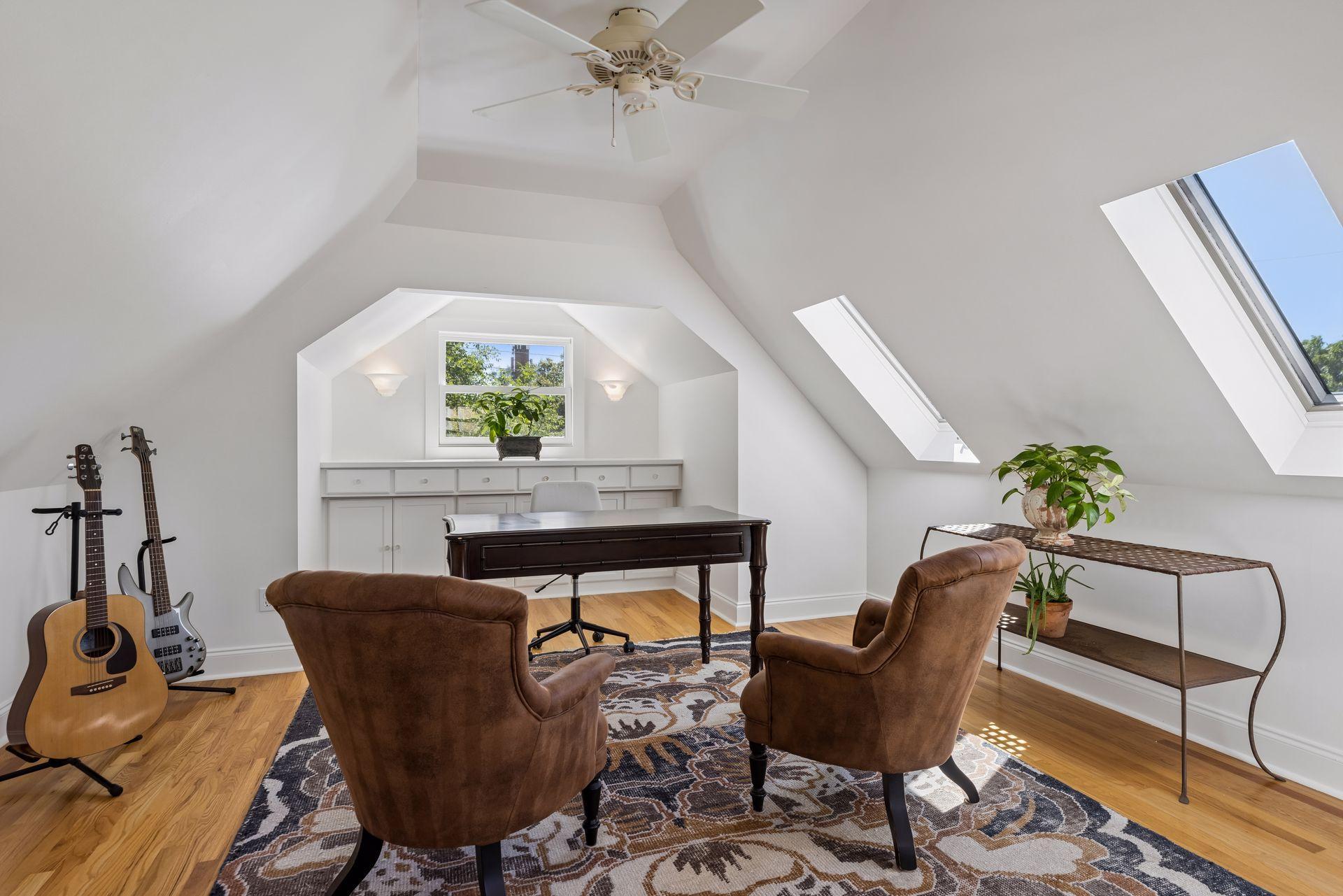 Vaulted upper level garage flex space with hardwood floors, sky lights and custom built-ins.