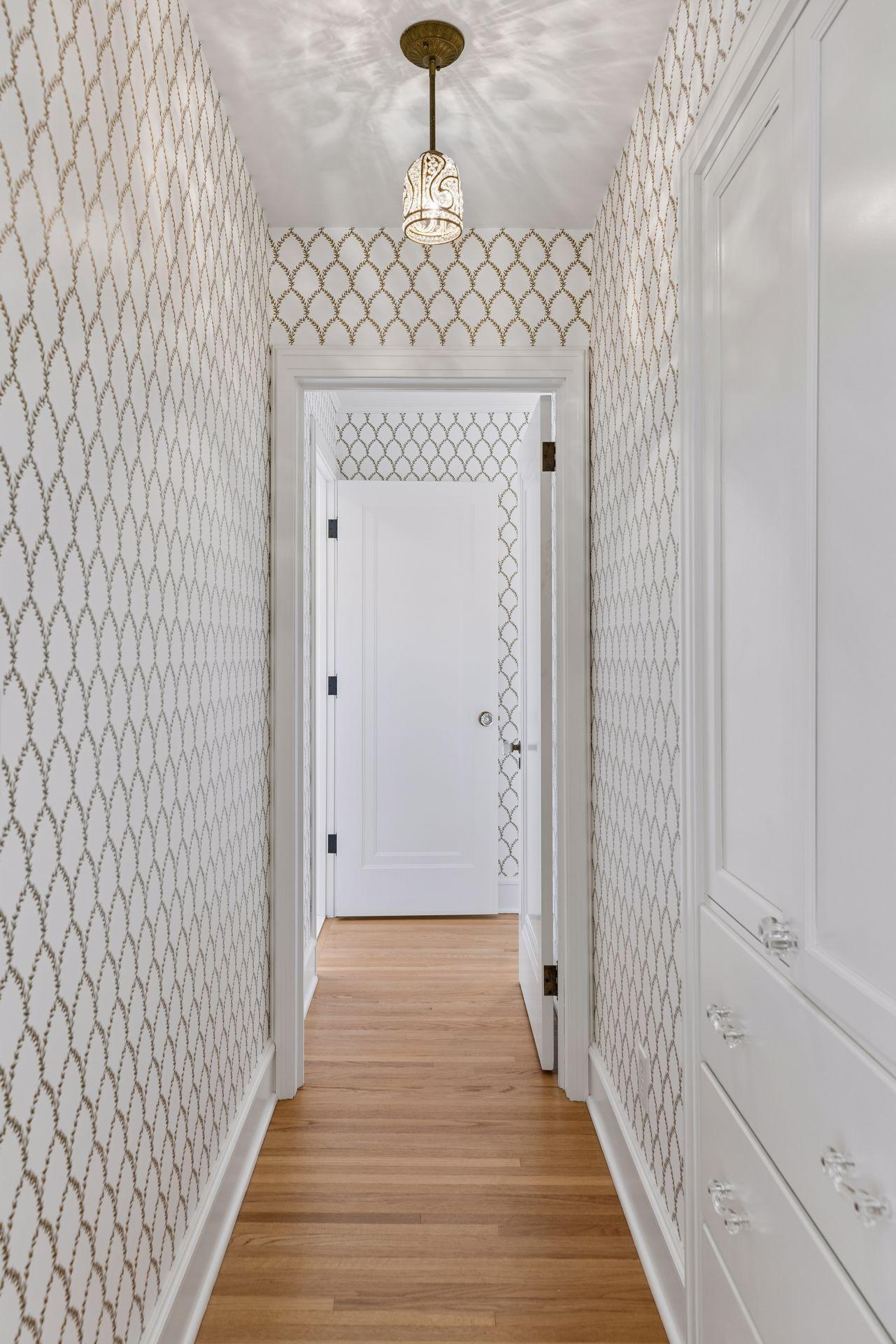 Hallway leading to primary suite adds privacy.