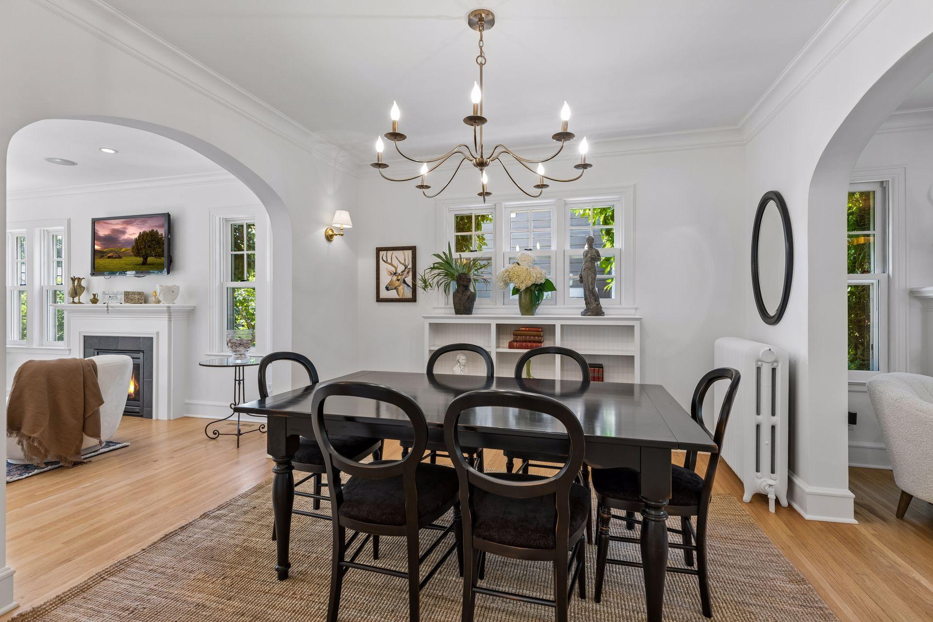 Dining room flows through archway into newer family room addition.
