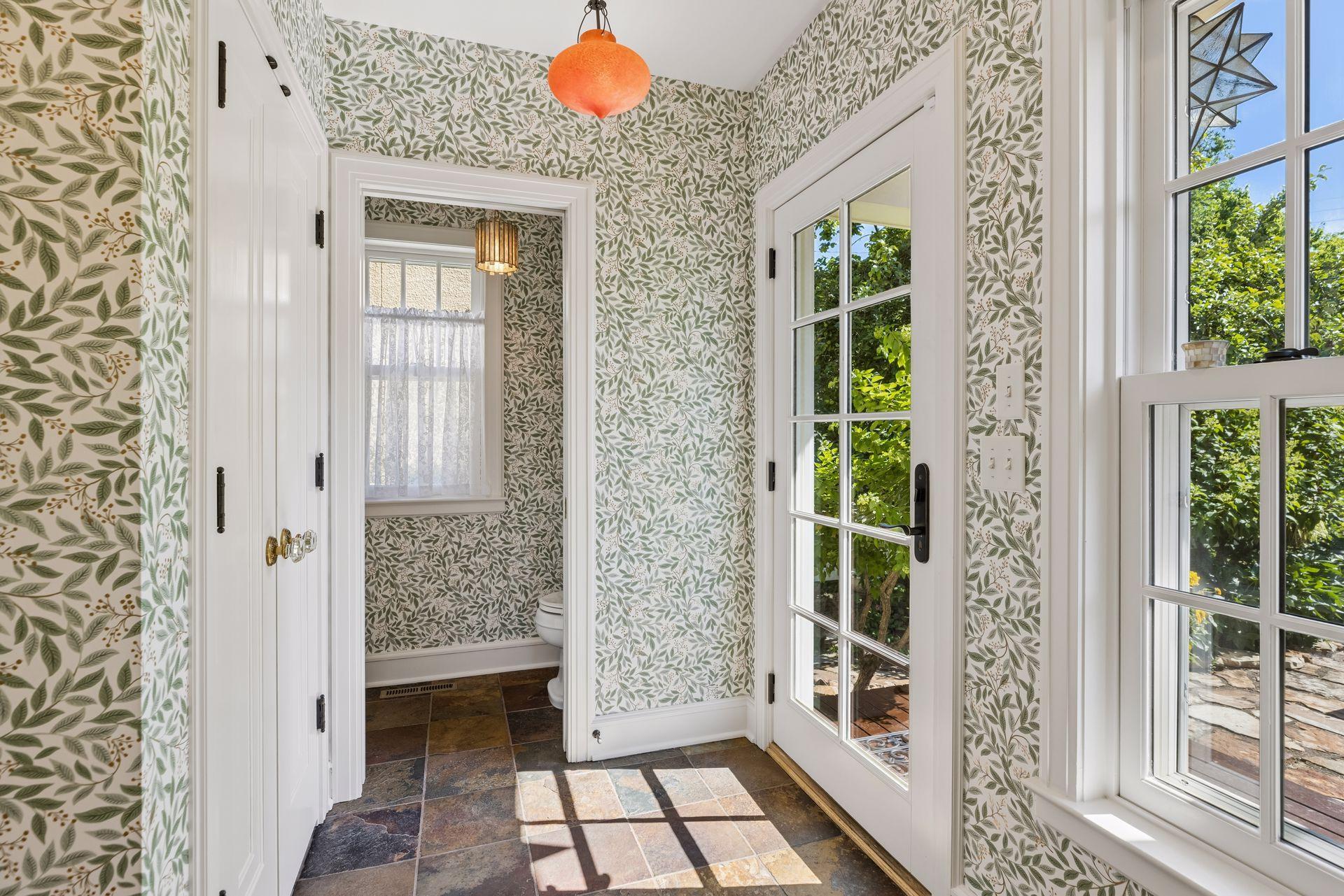 Light filled back entry with exceptional coat closet and newly done wallpaper adds warmth.