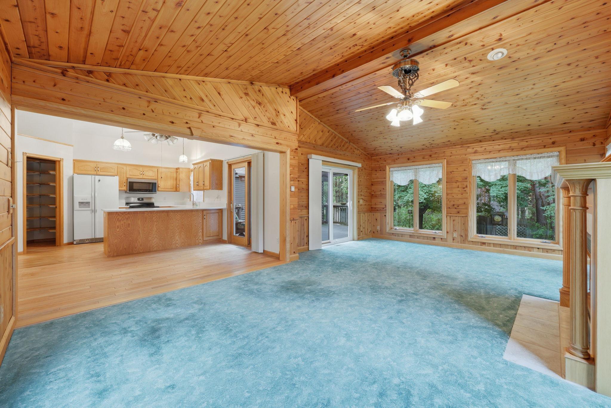Family room looking into kitchen/dinning & doors to deck