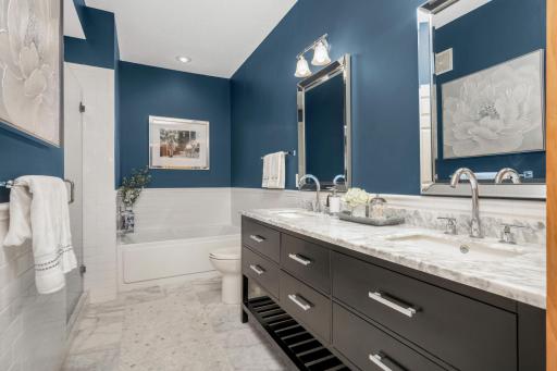 The primary bath is updated and features a beautiful walk-in shower along with a soaker tub and dual vanity.