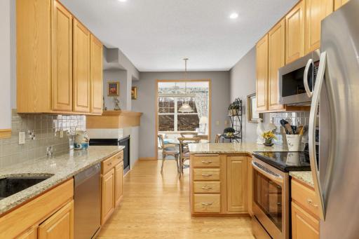 The kitchen features beautiful granite, updated stainless appliances, and hardwood floors.