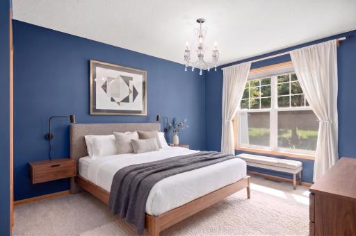 The main floor primary bedroom overlooks the backyard and features a spacious walk-in closet.