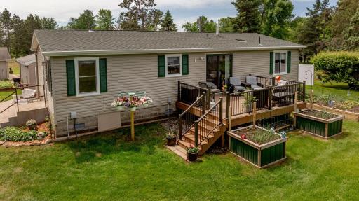 Beautiful backyard deck with great lake views and multiple raised garden beds!