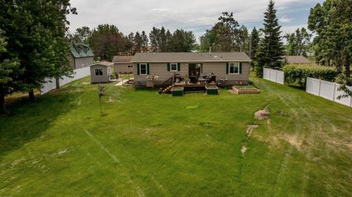 Pretty backyard with a privacy fence, and multiple raised garden beds.
