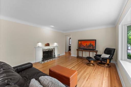 Here is the first glimpse of the living room as you enter the front door. The hardwood floors on the main level were refinished and gleam in the light. The fireplace with the recessed light above is a highlight of the LR.