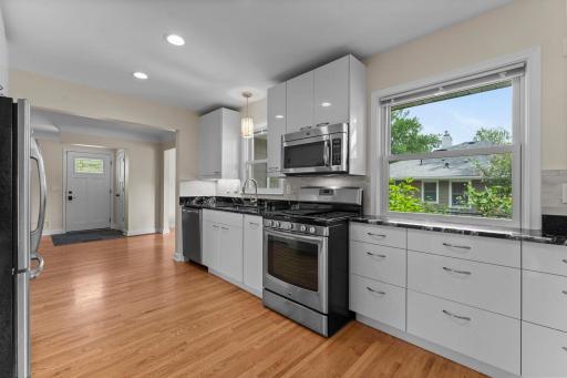The K was gutted in 2014. All new plumbing and electric wiring were installed. K features granite counters, new backsplash 2026, under cabinet lights, cabinets & counters extend into old informal DR, recessed lights added. Note no half wall.