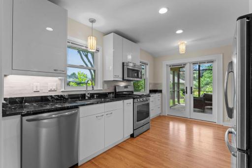 Beautiful French doors lead to the screen porch. The dishwasher was installed in 2025.