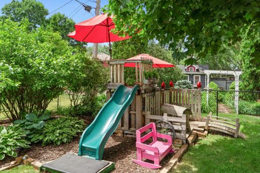 The backyard has a fort for the little ones to have adventures which includes a bridge to enter it.
