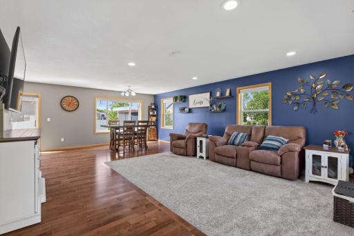 Spacious living room is filled with natural light and complemented by beautiful recessed lighting.