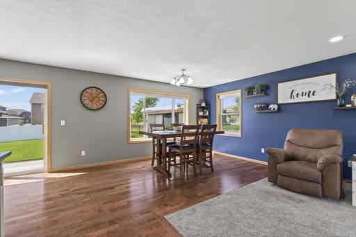 A bright dining space with a large backyard-facing window creates a welcoming spot for everyday meals and entertaining.