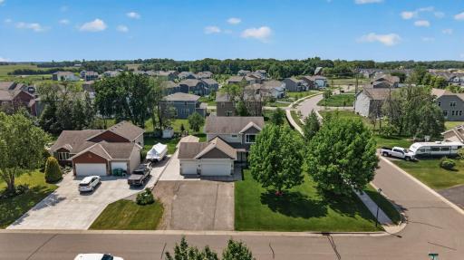 Mature trees, green grass, extra parking.