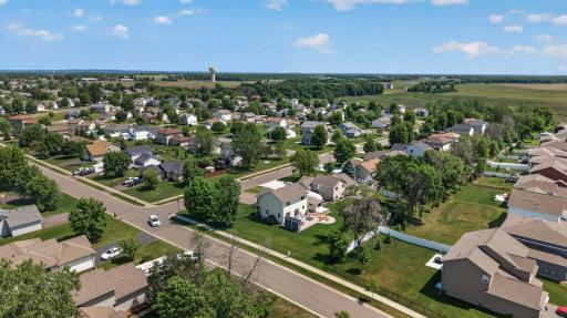Mature trees and beautifully maintained landscaping frame a spacious yard designed for both everyday living and entertaining.