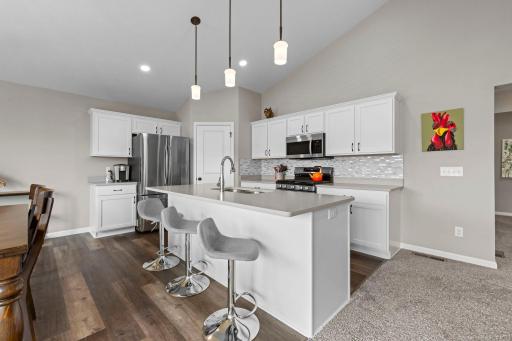 Kitchen with energy efficient faucet with Merillat kitchen cabinets and white trim throughout