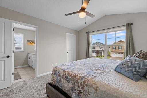 Owner's Suite with spacious owner's 3/4 bath with dual sinks and quartz countertops, and large walk-in closet.