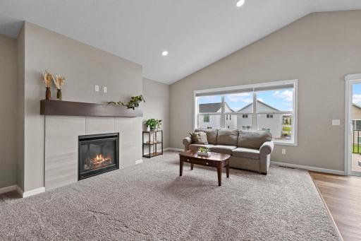 Gas fireplace with tile surround and with wood mantel plus fiber internet & outlet above mantel for convenience.