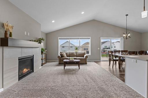 Living Room with Vaulted Knockdown Ceiling, Recessed Lighting, Large Maintenance Free Windows, Patio Door to Deck.