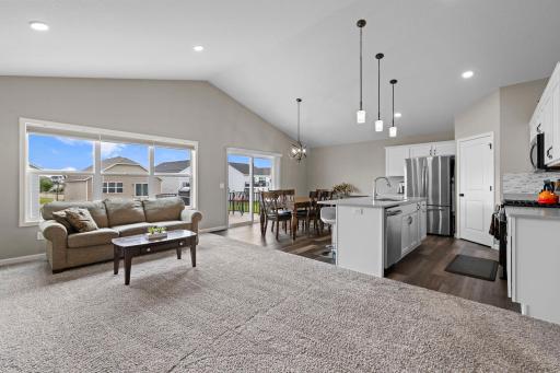 Enjoy the open concept with modern fixtures, breakfast bar, coffee bar, walk-in pantry, kitchen with center faucet and dishwasher and disposal, LVP flooring, backsplash, and high ceilings.