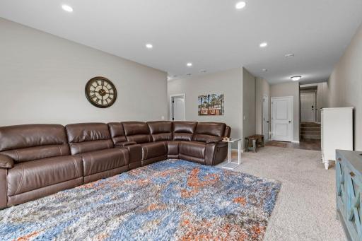 Large family room with recessed lighting and high ceilings.
