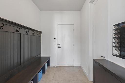 Designed for real-life, this functional garage entry offers a built-in bench, ample hanging space, and smart storage solutions to help reduce everyday clutter.
