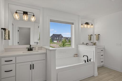 Start and end each day in a beautifully appointed primary en-suite bathroom featuring dual vanities and designer finishes throughout.