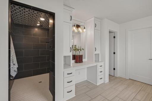 Elevate your daily routine with a luxurious walk-in shower, dedicated dressing vanity, and upscale finishes that bring a boutique hotel feel to your own home.