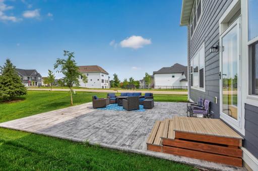 Whether you're grilling, visiting with friends, or soaking up the sunshine, this backyard setting is ready for it all.