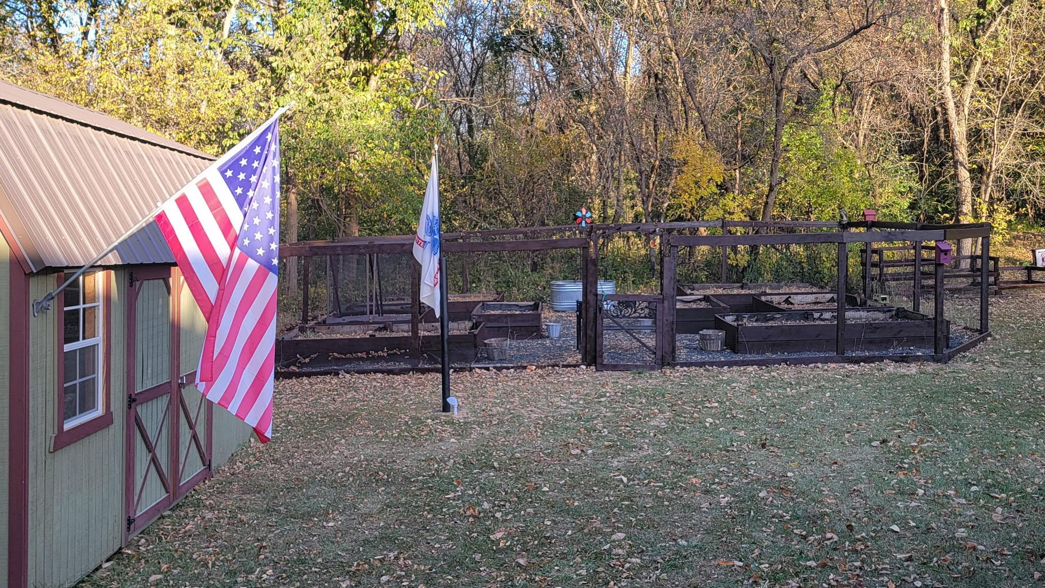Raised bed garden with fencing surround to keep the deer out.