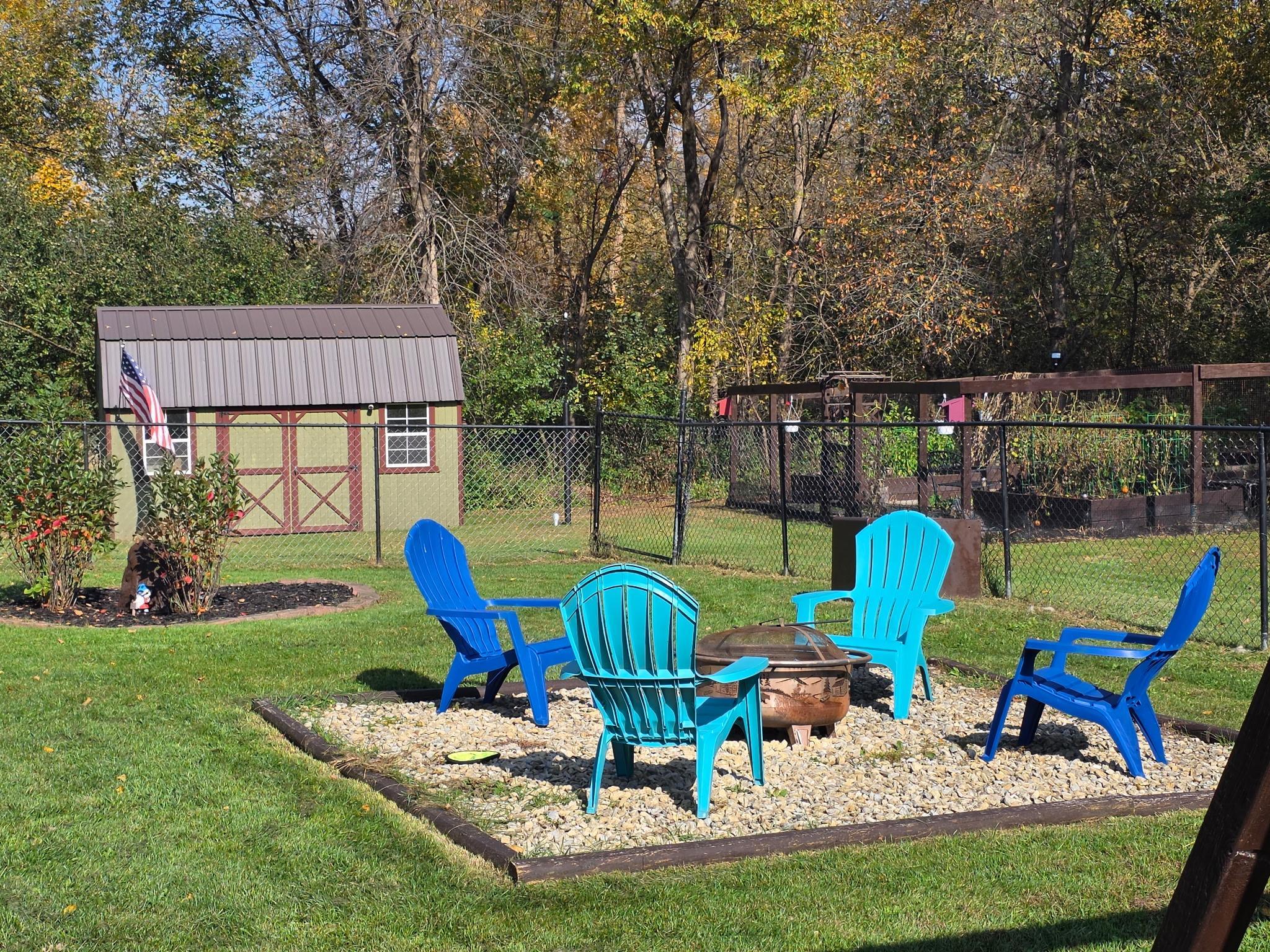 Backyard fire pit to relax on nice summer evenings. Garden shed for all your gardening/lawn tools.