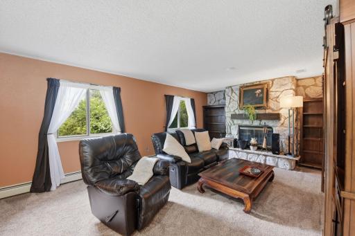 Cozy living room with a woodburning fireplace.