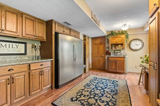 Kitchenette in lower level is a great staging area for your outdoor BBQ. Refrigerator & freezer will stay. Makes outdoor entertaining a breeze! Note the granite countertops and the sink for quick cleanups.