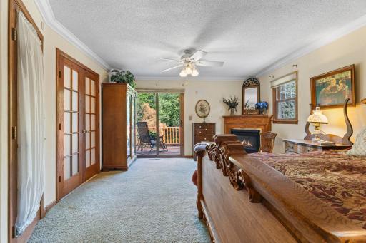 Frosted french doors lead to the walk-through bath. Private deck off the primary bedroom. Note the gas burning fireplace.