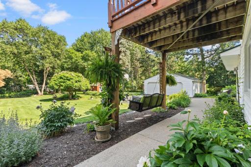 Sidewalk runs between patios on either end of the house.