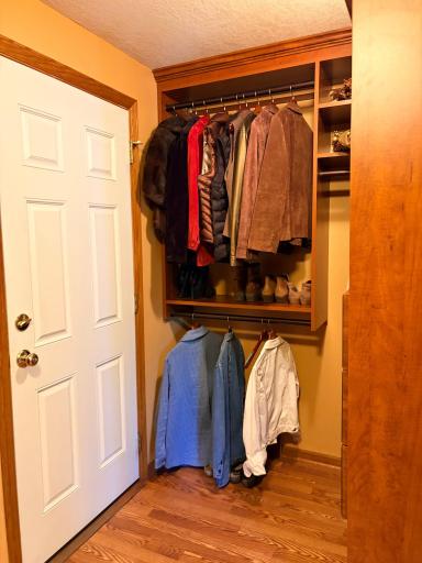 Mudroom with garage entry on the far end of the kitchenette features custom built storage by California Closets.