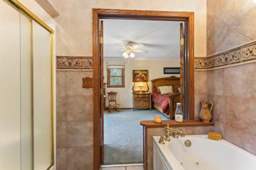 Walk through upper level full bath features double sinks and a separate tub and shower.