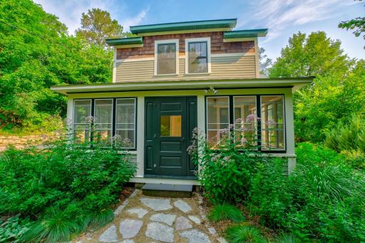 Welcome to this best-of-all-worlds North Hill home, tucked in wooded privacy just a 10-minute walk to bustling downtown Stillwater. This front porch hearkens back to the original home and is beautifully incorporated into the new design.