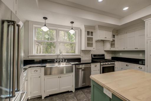 Everything you need in a kitchen is right here! Note the stainless farm sink with double windows to the side yard.
