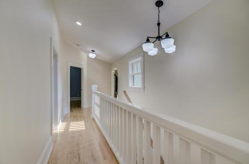 Hallway to the third bedroom. The door to the left leads to a full bathroom.