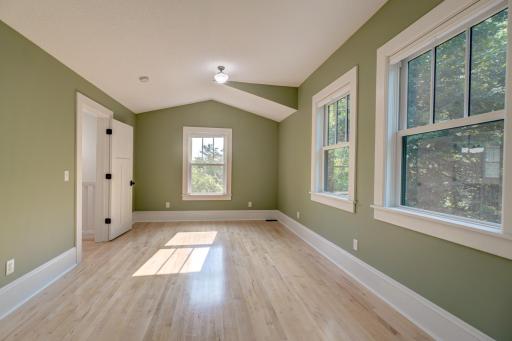 Another soft vault to the ceiling. This room has a double closet and windows in three directions.