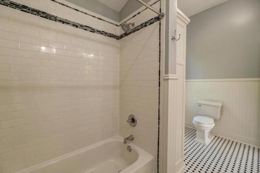 The wainscoting and white subway tile are appealing and timeless elements seen throughout the home.