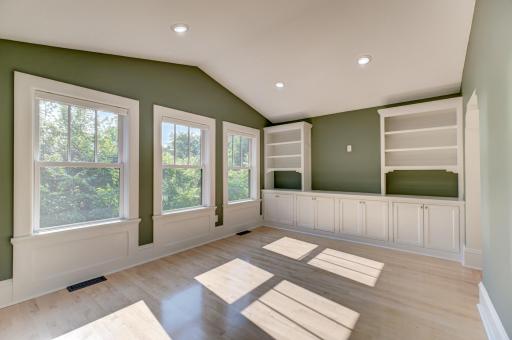 The fantastic family room adjacent to the primary suite has space for a TV between the built-ins along the south wall.