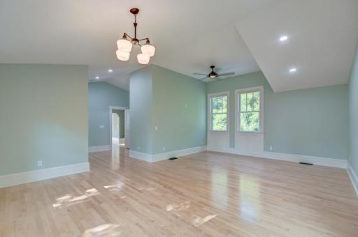 The vast primary suite includes a flex room between the door to the suite and the adjoining family room.