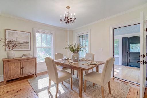 This shot is virtually staged to show the front room as a dining room space leading out to the front porch.