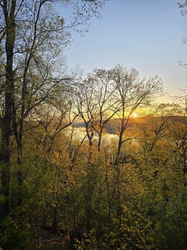 A shoulder season view of the sun rising over the river bluffs.