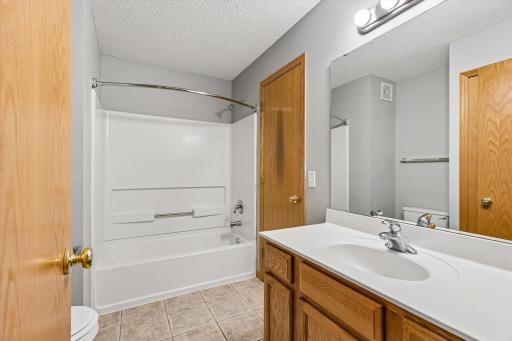 Spacious soaking tub with shower.