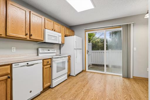Walk-out patio with easy access from this beautiful kitchen. New glass has been ordered for the sliding glass door.